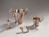 silver plated wine buckets, cups, and spoons on a table