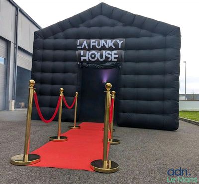 a giant inflatable house with a red carpet on the ground