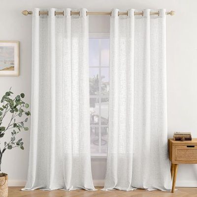 the gray and white curtains are hanging on the window sill