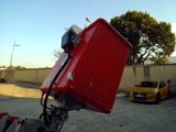 a red piece of luggage sitting on top of a car