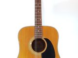 a guitar that is sitting on a stand on a white background