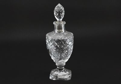 an image of a clear glass perfume bottle on a black background