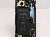 the back of a cell phone with a broken battery attached to it
