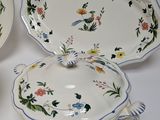 three plates and a bowl on a white table