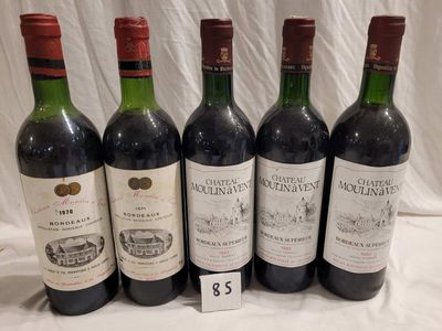six bottles of red wine are lined up on a table