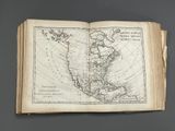 an old book with a map of the americas on it