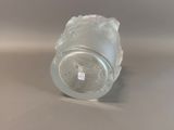 a clear glass vase with a white label sitting on a table