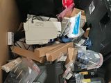 a cardboard box full of electronic equipment and other items