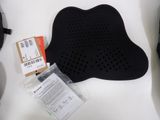 a black seat cushion and a pair of shoes on a white table