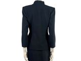 a mannequin wearing a black suit and skirt on a mannequin mannequin mannequin mannequin mannequin mannequin manne