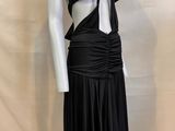 a mannequin with a black dress on a mannequin base