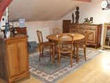 a table and chairs in a room with a rug on the floor