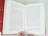 a person holding an open book in their hand