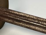 a close up of a metal object on a white surface