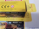 two boxes of dinky toys sitting on a table
