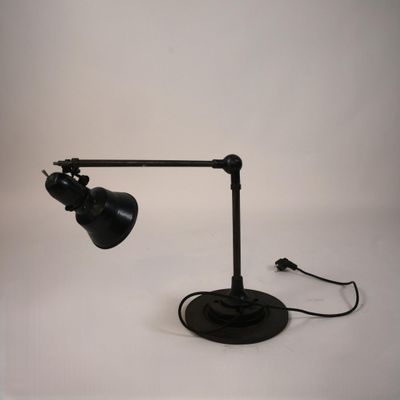 a black lamp that is on a white table