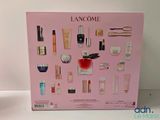 the contents of the lancome beauty set are displayed in a pink box