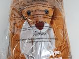 a stuffed animal in a plastic bag on a table