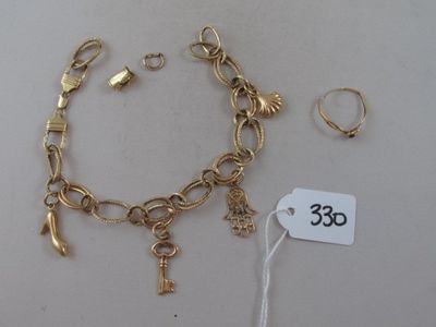 a gold bracelet with charms and a key on it