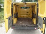 a yellow van with its doors open on the side of the road