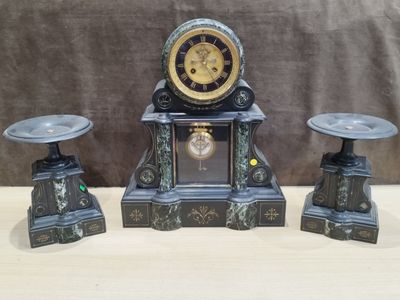 a clock sitting on top of a table next to two stools