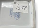 a small white plate with a tag on it