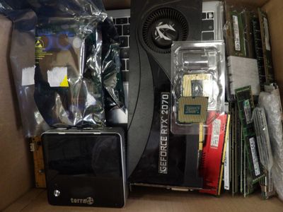 a box full of electronics and a laptop in it