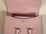 the small pink purse is open and ready to be used