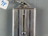 a silver lighter with a tag attached to it