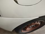 a close up of a white car with a flat tire