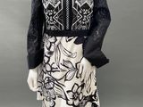 a mannequin wearing a black and white dress with a floral pattern