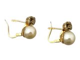 une paire de boucles d'oreilles en perles et en or sur fond blanc