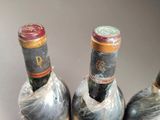 three bottles of wine that are wrapped in plastic