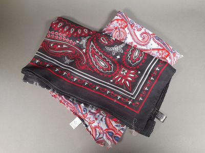 two red and black bandas on top of each other on a table