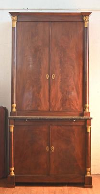 a wooden cabinet and a suitcase in a room