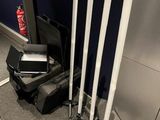 three baseball bats and a laptop on the floor