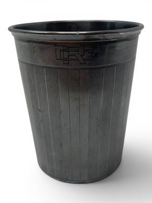 a metal trash can with a black lid on a white background