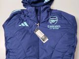 a close up of a blue jacket with a tag on it