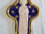 an image of a blue and gold cross with a statue of a woman