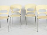 four yellow chairs sitting next to each other on a white floor