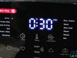 a digital clock on top of an air fryer