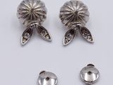 two pairs of silver plated ear clips and a pair of silver plated ear clips
