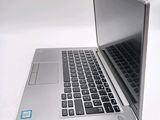 a silver laptop with a blue sticker on it