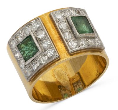 a close up of a gold ring with emeralds and diamonds