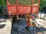 a red truck with a hose attached to the back of it