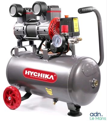 a small air compressor with a gauge on top of it