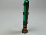 a green bottle with a cross on it sitting on a table