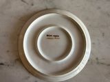 a white plate with a brown inscription on it