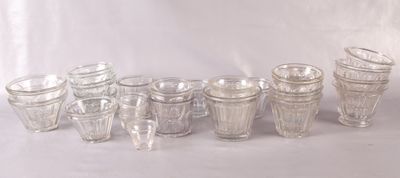 a lot of glasses that are lined up on the table