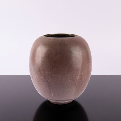 a brown vase sitting on a black table